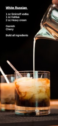 a white russian is being poured into a glass