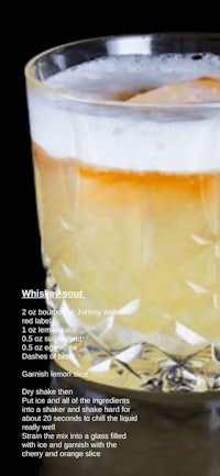 a glass of whiskey sour with ice in it