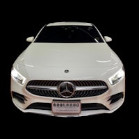 a white mercedes cls-class sedan on a black background